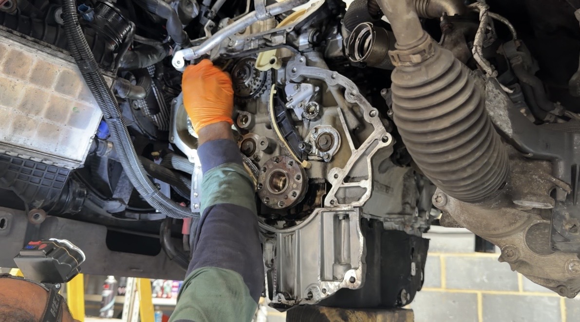 Technician working in an engine bay at KITH Cars Garage & Bodyworks, Hackbridge