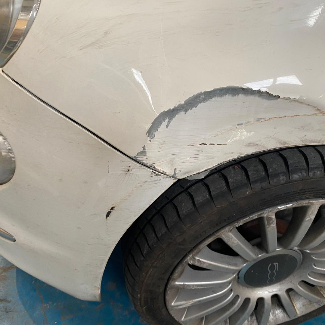 Fiat 500 side fender damage — before bodywork repair