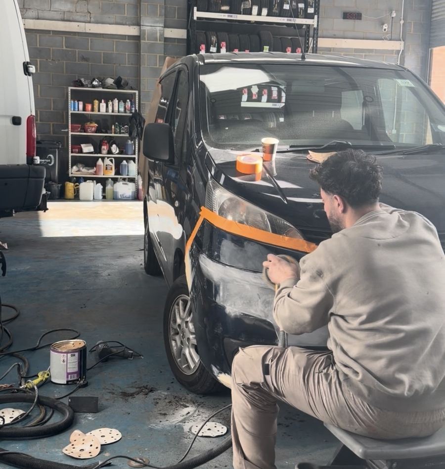 Painter preparing a car in the KITH bodyshop