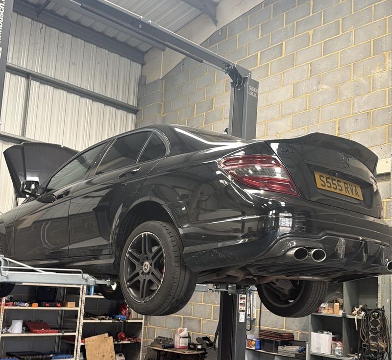BMW on a two-post lift in the mechanical workshop